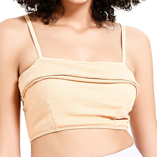 一位女士身穿 橙色-MIX&MATCH泳衣上身 <23551578>,這是一件淺米色、無袖、有細肩帶的羅紋裁剪上衣。只看得到她的上半身和部分捲髮。.