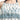 身穿深藍色三件套日本製泳衣 <134506-TQ>的女性特寫，無袖白色上衣，領口和下擺飾有藍色和茶色的花卉與幾何圖案。.
