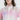 一位女士穿著粉紫色超薄防風外套 <201221817-112>，短款、連帽、超輕設計和 Voler 標誌。粉紫色超薄防風外套 <20121817-112> 採用短款連帽超輕量設計，並印有 Voler 標誌。.