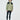 A person with medium-length brown hair wearing an 杏色2合1撥水防風外套 <20621678-12>, black leggings, and black athletic shoes, standing against a plain white background，展現都會休閒風格。.