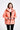 Woman wearing a pink jacket on a white background