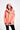 Person wearing a peach-colored raincoat on a white background
