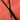 Close-up of a black zipper on a pinkish-red fabric surface
