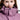 Close-up of a person wearing a purple jacket with a hood.