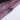 Close-up of a purple fabric with a zipper on a white background