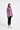 Woman wearing a pink jacket on a white background