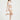 一位女士為白色-MIX&MATCH泳衣下身 <24051531>比基尼下身做模特，單腿站立，背景為純白背景，表情輕鬆地微微側頭。.